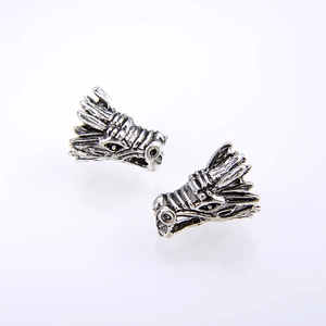 Vintage silver dragon head earrings with intricate mythological scales and carvings