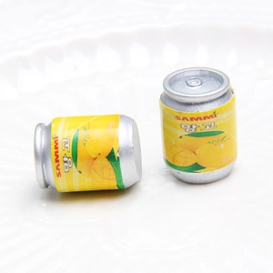 Macro shot of miniature soda cans with mango design for DIY craft and keychain charm