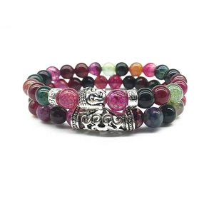 Detail of beaded bracelets featuring multicolor crackle beads and silver Buddha charm