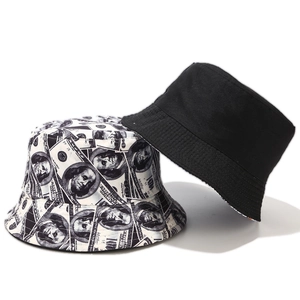Detail of reversible bucket hat showing dollar bill print and solid black cotton fabric