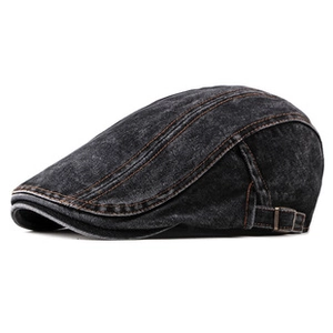 Close-up of retro washed denim beret with brown contrast stitching and metal buckle