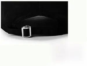 Detail of black baseball cap showing the silver metal adjustable buckle and fabric texture