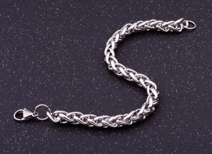 Detail of silver stainless steel wheat chain bracelet with secure lobster clasp