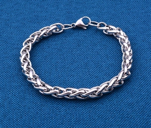 Detail of silver stainless steel wheat chain bracelet with secure lobster clasp