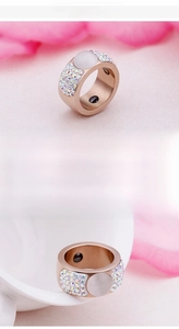 Detail of rose gold magnetic ring with opal stone and rainbow rhinestones