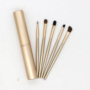 Five champagne gold eye makeup brushes with horse hair and a matching cylindrical case