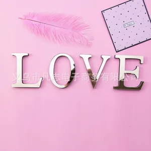 Silver mirror acrylic decorative 3D wall sticker letters spelling LOVE on pink background