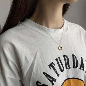 Detail of elegant gold twisted wreath pendant necklace on model with polished finish
