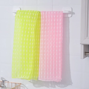 Detail showing the honeycomb texture of yellow and pink nylon back scrubber towels