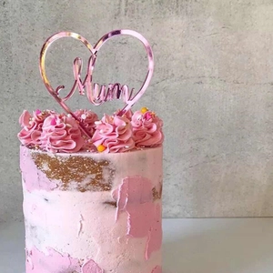 Pink mirror acrylic heart cake topper with Mum lettering on pink frosting cake