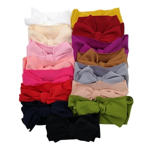 Baby headband collection with large textured waffle bows in various vibrant colors