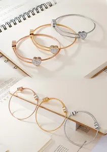 Detailed trio of silver gold and rose gold heart cable bracelets with zircon inlay