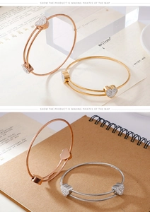Detail of twisted cable heart bracelet in rose gold, gold, and silver finishes