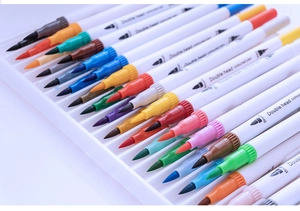 Close-up of double-headed watercolor brush pens with vibrant color caps in a tray