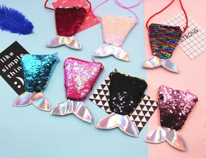 Flat lay of colorful sequined mermaid tail coin purses with iridescent PU material detail