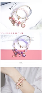 Detail of dolphin and shell charms on beaded ocean-themed bracelets with pastel tones