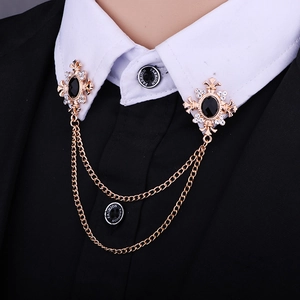 Detail of gothic cross collar brooch with black gemstones and double gold chains