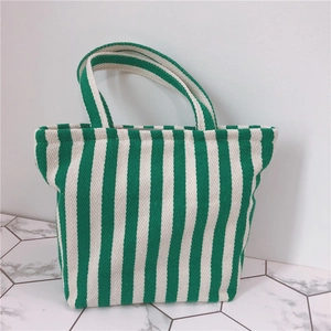 Close-up of thick green and white striped canvas tote bag with textured fabric detail