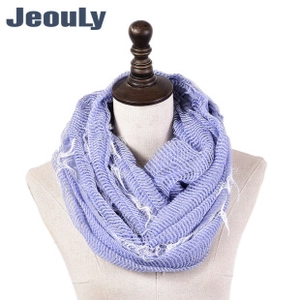 Detail of purple wrinkled texture scarf with frayed fringe edges on a mannequin stand