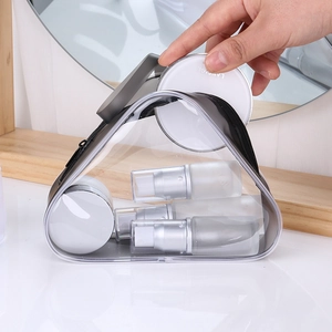 Clear PVC travel cosmetic bag with zipper and portable handle showing toiletry bottles