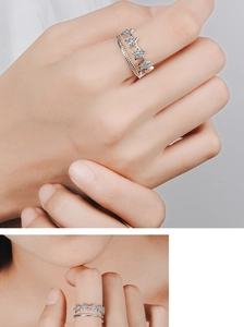 Detail of double-layer silver star ring with shimmering crystals on model hand