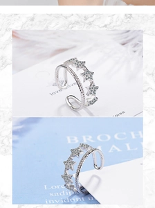 Macro detail of silver double-layered open ring with sparkling star zircon embellishments