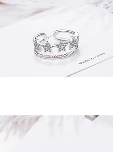 Detailed close-up of double-layer star ring with zircon inlay and twisted silver band