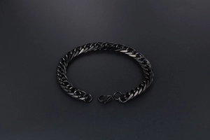 Close-up of a minimalist black stainless steel link chain bracelet with a secure clasp