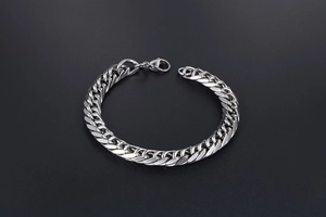Detailed shot of polished stainless steel chain bracelet with secure lobster clasp closure