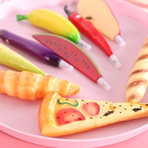 Creative food and fruit shaped ballpoint pens set on a pink tray for office use