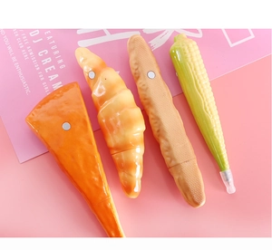 Detail of food-shaped ballpoint pens with magnetic backing on a pink background