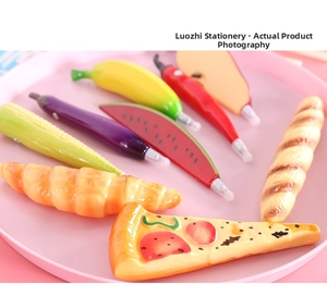 Macro view of novelty ballpoint pens shaped like vibrant fruits and vegetables in a tray