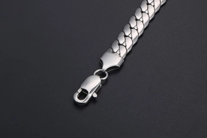 Close-up of silver stainless steel Cuban chain bracelet with a smooth lobster clasp finish