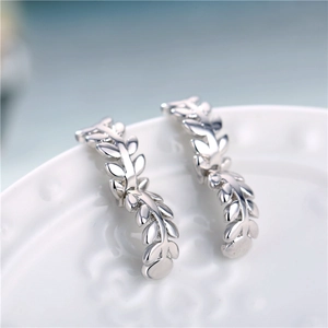Fashion silver leaf branch hoop earrings made of gold-plated copper on white plate