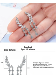 Detailed view of silver zircon wing earrings with tassel fringe and size measurements