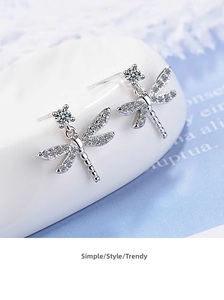 Detailed close-up of dragonfly earrings with sparkling crystals and silver finish