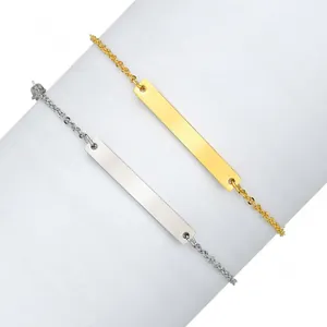 Detalle de pulseras de barra pulidas en oro y plata sobre un soporte blanco