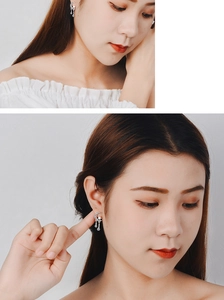 Detailed close-up of moon and star silver earrings with sparkling rhinestones on model