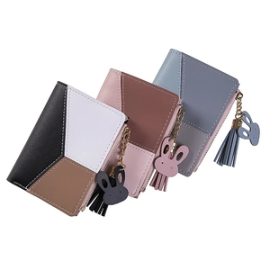 Detailed view of women's short patchwork wallets with tassels and rabbit charms