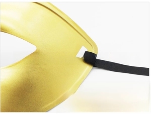 Detail of the elastic band attachment on the gold masquerade mask for a secure fit