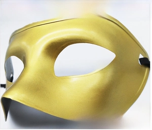 Close-up of golden phantom mask with metallic paint finish and black ribbon ties