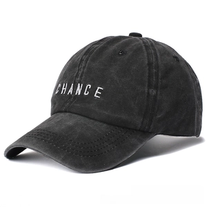 Detailed embroidery of CHANCE letters on a washed black cotton baseball cap