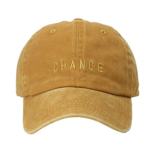 Detailed embroidery of CHANCE lettering on washed cotton mustard yellow baseball cap