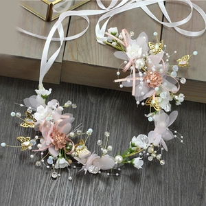 Detail of bridal floral headband with pink silk flowers, pearls and golden butterflies
