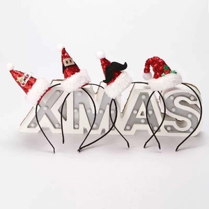 Set of four sequin Christmas hat headbands with XMAS light decoration on white background