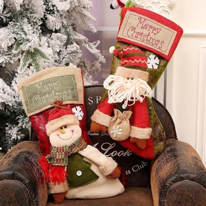 Large vintage Christmas stockings with Santa and Snowman hanging decorations for holiday party
