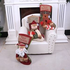 Large vintage Christmas stockings with 3D Santa, Snowman and Reindeer on a fireplace mantle