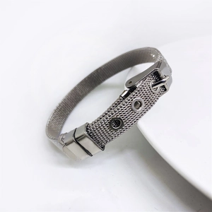 Detail of silver mesh bracelet with adjustable buckle on minimalist white porcelain
