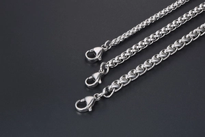 Three sizes of silver stainless steel keel chains with lobster clasps on grey background