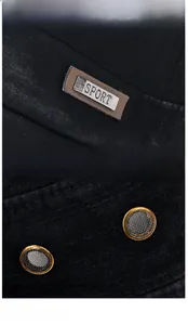 Detail of metal SPORT logo and breathable mesh ventilation holes on washed cotton flat cap